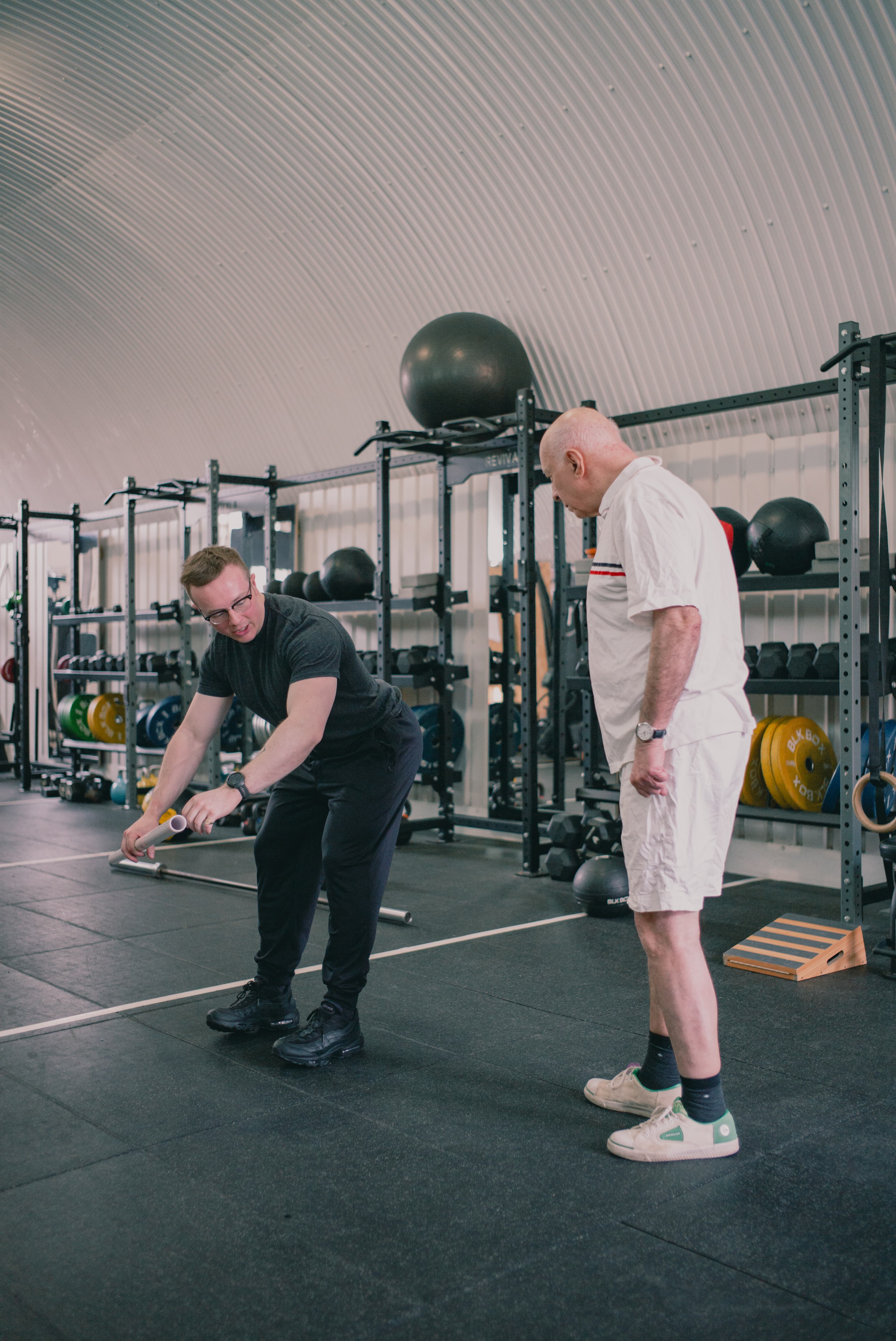 Harry Phillips coaching an older client at West 4 Gym. The same conservative loading approach used for post-knee-replacement work